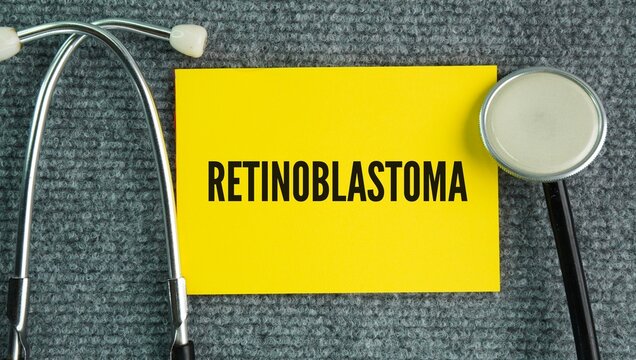 Stethoscope and paper with the words Retinoblastoma is a rare, fast-growing malignant cancer that develops in the retina