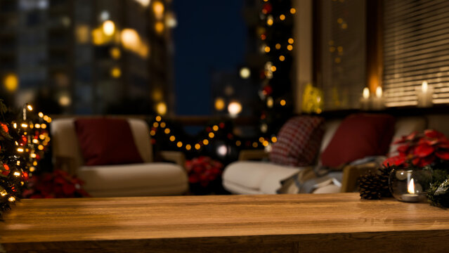 Christmas Decorated Balcony at Night with Wooden Table Foreground, Bokeh City Lights and Festive Holiday Decor
