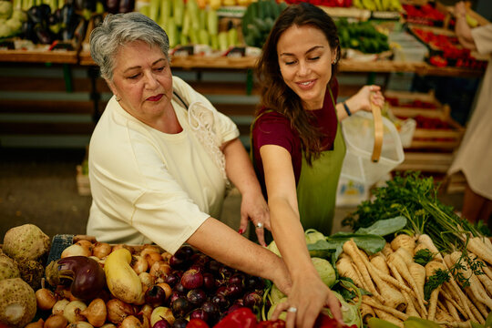 Women buying fresh organic vegetables at farmer's market