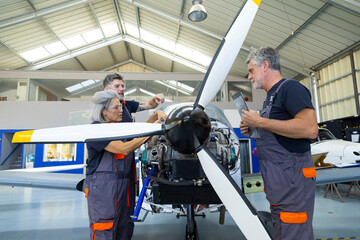 Aviation engineers team inspecting airplane engine propeller © luisrojasstock