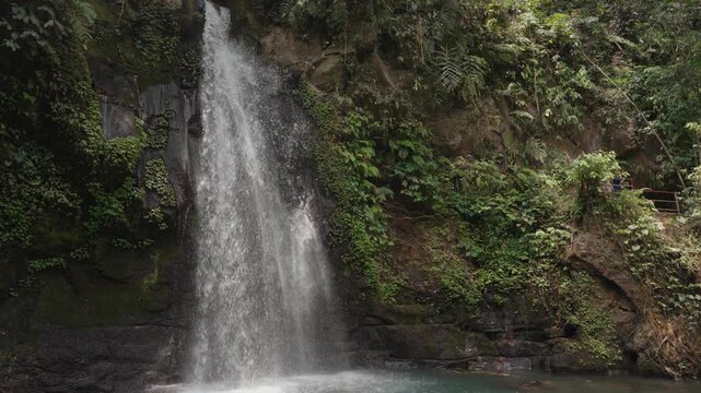Ulu Petanu Waterfall Cascading Down a Rocky Cliff Amid Lush Tropical Forest in Slow Motion, Tegallalang, Bali, Indonesia