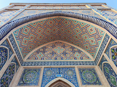 Ornate tilework facade of Ulugh Beg Observatory in Samarkand featuring geometric and floral mosaic patterns. Ideal for travel publications, cultural heritage materials, and architectural design.
