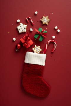 Merry Christmas vertical stocking with candy cane cookie and wrapped gift for Happy New Year celebration