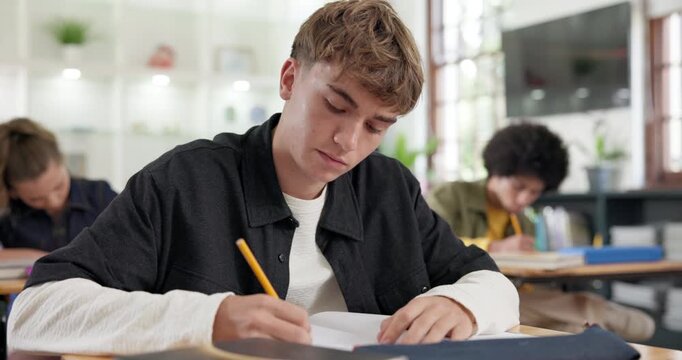 College, books and man in classroom for writing, learning and education for university course. School, academy and student with notes, assignment and lecture for knowledge, development and lesson