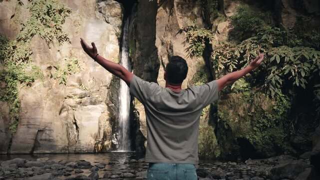 Adult male embracing nature at salto do cabrito waterfall