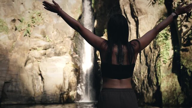 Woman embracing nature at salto do cabrito waterfall