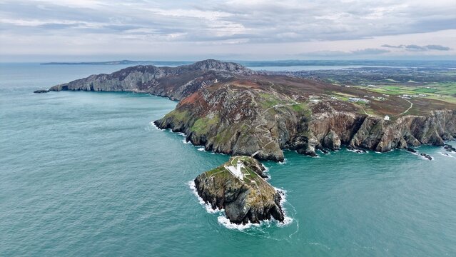 Aerial drone view of rugged South Stack sea cliffs and coastline near Holyhead, Isle of Anglesey, Wales