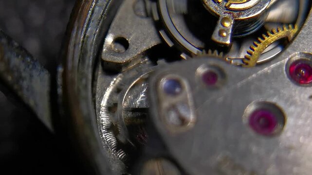 Top view macro shot of watch caliber with ruby jewels and pulsing balance spring