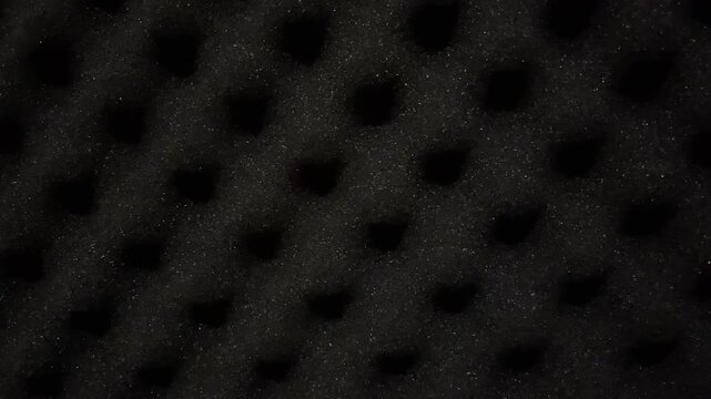 Macro texture of black styrofoam beads for modern furniture filler