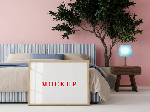 Empty poster frame mockup above bed in minimalist bedroom interior design.
