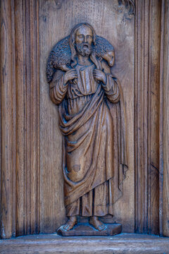 Yonne, Burgundy, France. A low relief carved from oak depicting Christ the Good Shepherd carrying a sheep on his shoulders, Saint-Jean-Baptiste Church in Joigny, Yonne.