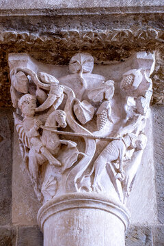 Romanesque capital from the Basilica of V&eacute;zelay depicting a hunter blowing a horn, his horse, and a dog on a leash. Yonne, Burgundy, France