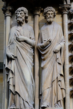 Saint-Etienne Cathedral, Metz, Moselle, France. Two stone statues of apostles, draped in long cloaks and each holding a Gospel