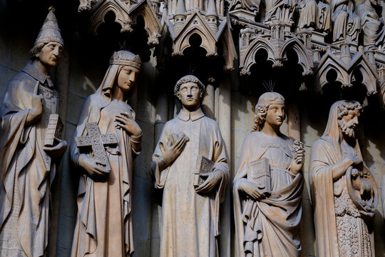 Saint-Etienne Cathedral, Metz, Moselle, France. Five stone statues of saints, sheltered beneath Gothic canopies above the cathedral&rsquo;s portal, are depicted holding their attributes.