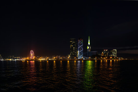 Batumi night skyline with a brightly lit Ferris wheel