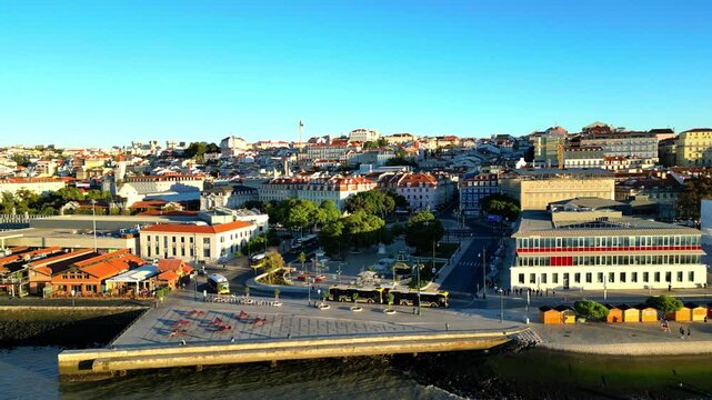 Circular aerial view above Pra&ccedil;a Duque da Terceira in Cais do Sodr&eacute;, revealing Lisbon historic waterfront, vibrant urban landscape and the iconic riverside district along the Tagus River.Portugal