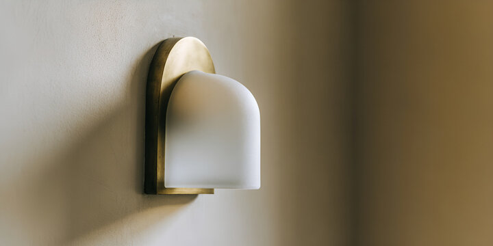 Byzantine revival wall lamp with matte brass backplate and frosted shade on warm plaster wall