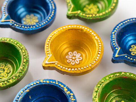Beautifully Hand-Painted Decorated Clay Diya Lamp Isolated on a Clean White Background, Traditional Diwali Studio Product Shot
