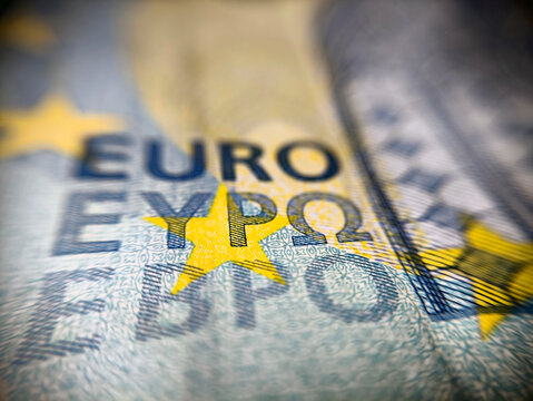 Macro Extreme Close Up of Euro Text in Different Alphabets and Yellow Stars on Twenty Euro Banknote