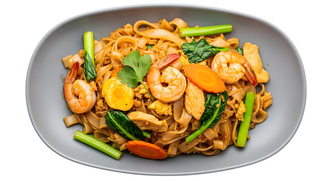 Delicious pad see ew with shrimp chicken and fresh vegetables on plate