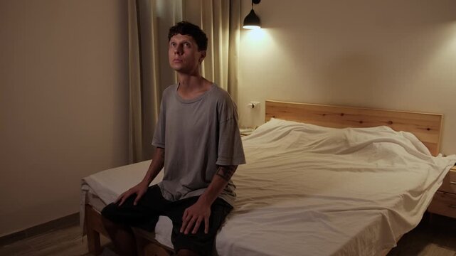 Man practicing grounding and mindfulness by slowly observing his surroundings and then focusing on his hands, reconnecting with the present moment through body awareness and self regulation