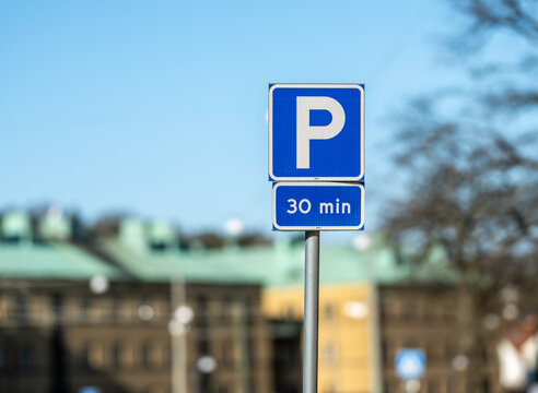 Blue parking sign indicating thirty minute time limited parking zone.