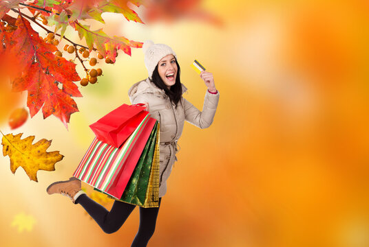 Happy Woman Carrying Shopping Bags and Credit Card During Autumn Shopping