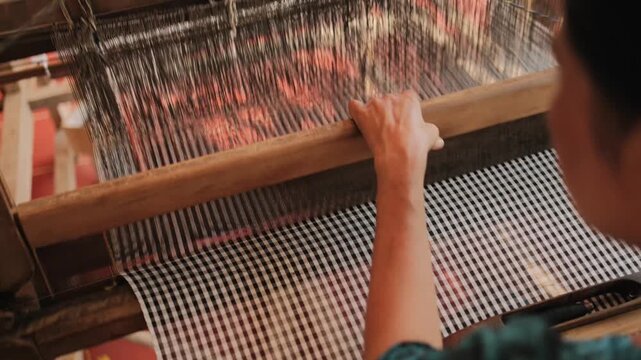 Cham woman weaves patterned cloth in Chau Phong, Vietnam