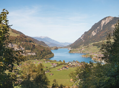 Swiss mountain village with lake and mountains. Beautiful panorama of Lungern and Lungernsee in Obwalden from Ch&auml;lr&uuml;tirank viewpoint. Central Switzerland and Br&uuml;nig Pass. Selective focus.