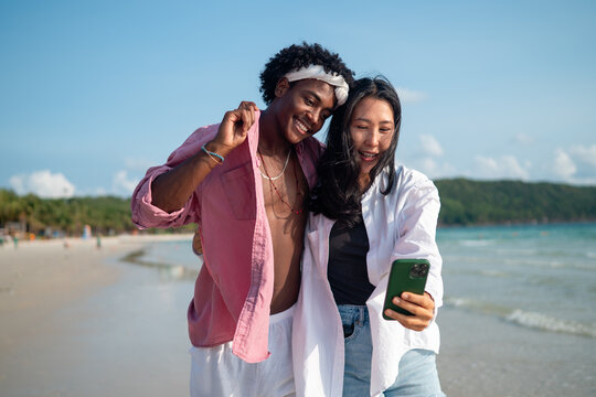 Interracial couple enjoying a romantic beach getaway, embracing love, laughter, and togetherness