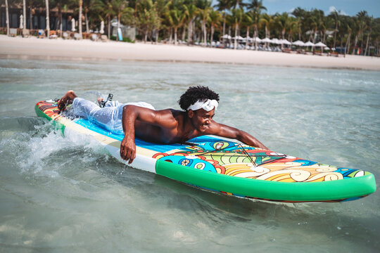 Luxury beach resort vacation with young man, tourist enjoying water activities on summer vacation