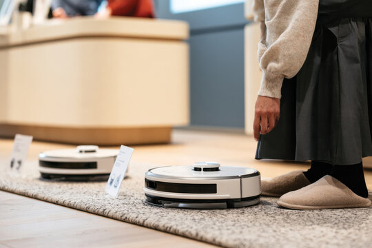 A modern robot vacuum cleaner operates on a textured rug in a beautifully designed indoor space, representing innovation in household chores blending functionality with style.