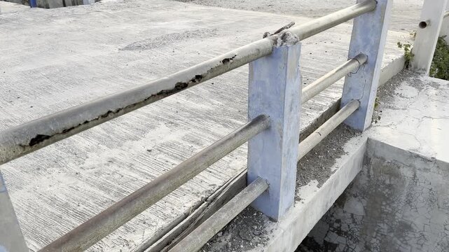 Old rusty metal railing on concrete water gate