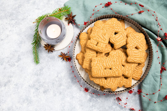 Spekulatius cookies or biscuits, spiced gingerbread with cinnamon, anise stars and cardamom, traditional christmas holiday pastry, homemade bakery, candle light