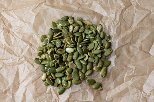 Green Pumpkin Seeds on Crumpled Paper