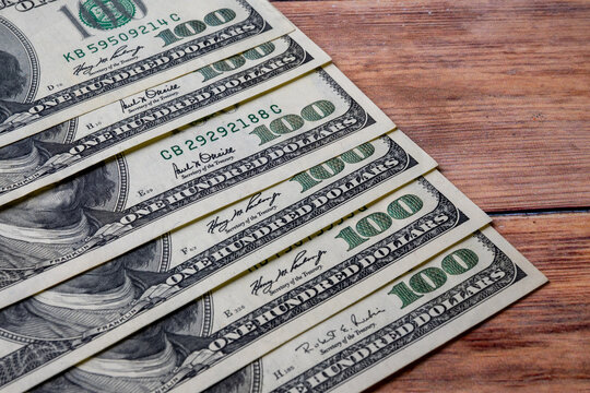 US Dollar Banknotes Arranged on Wooden Surface