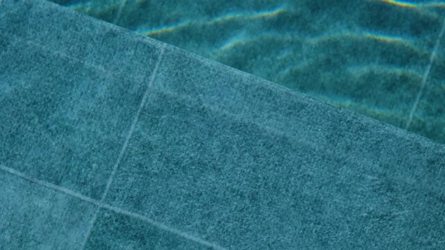 Water surface reflection on textured pool tiles with light patterns