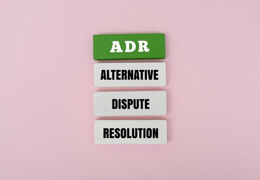 Colorful blocks with the text ADR - ALTERNATIVE DISPUTE RESOLUTION. Symbolizing organized and peaceful legal mediation and conflict management