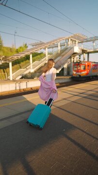 Caucasian woman pulling a suitcase and running, late for train.