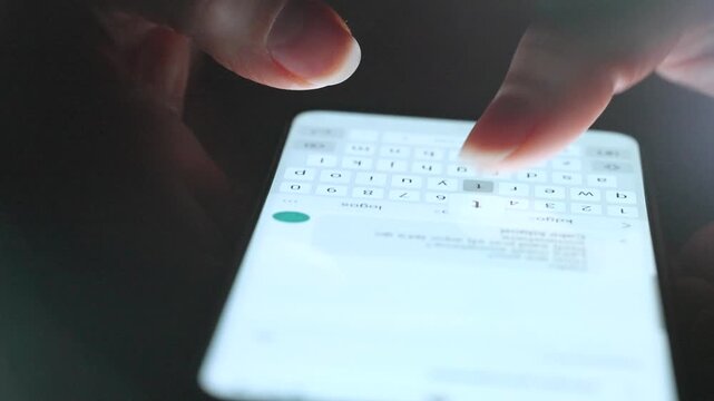 Female hands typing text on smartphone close-up.