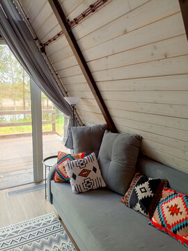 interior of a wooden house, living room with sofa and pillows