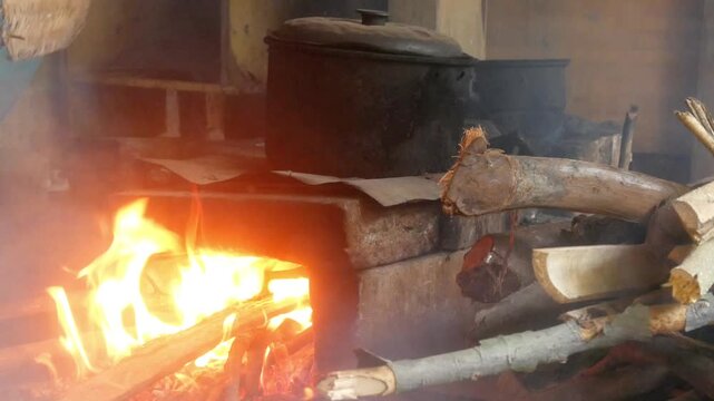 traditional country kitchen using a wood burning stove with a black pot on top
