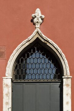 Gothic architectural archway with ornate stone carvings and dark wooden door architecture entrance building structure medieval historic ornament ironwork craftsmanship tradition heritage