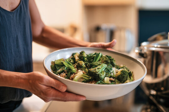 A delightful display of green vegetables is presented in a bowl, emphasizing health and vitality, ready to nourish the body and satisfy the senses in a cozy kitchen.