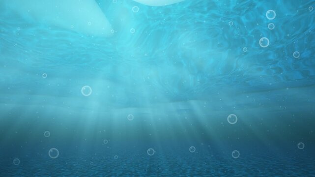Underwater sunbeams illuminate ocean depths with gentle bubbles and subtle motion