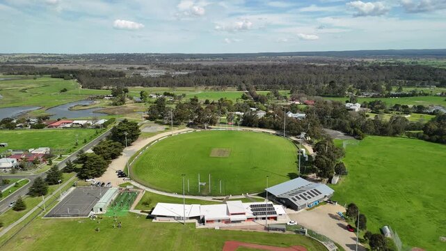 Sale, Victoria, Australia &ndash; 4K aerial drone view of green Australian rules football oval, baseball field, sporting facilities, wetlands and residential neighbourhoods in Gippsland