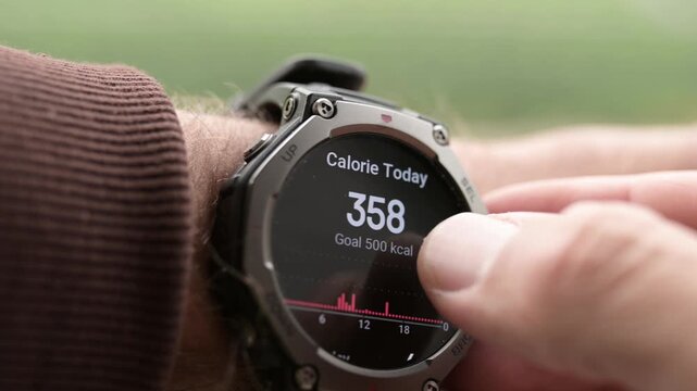 Man checking daily burned calories on rugged smartwatch close up