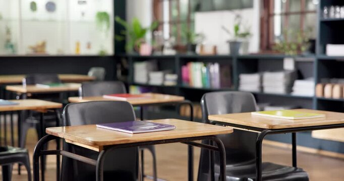 Education, notebook and desk in college for study, learning material or research in empty classroom. Stationery, campus or table in school for growth, development or scholarship opportunity in lesson