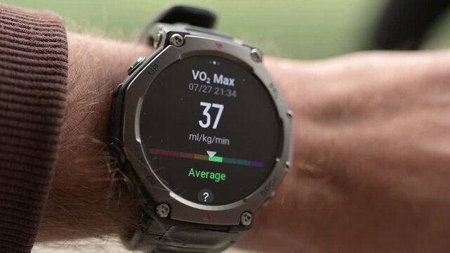 Close-up of rugged smartwatch on wrist showing VO2 max fitness level reading