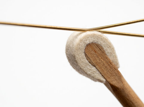 Macro Shot Of Piano Action Felt Hammer Striking